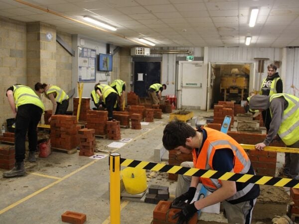 Brick students building walls as part of the KFE Skills Competition