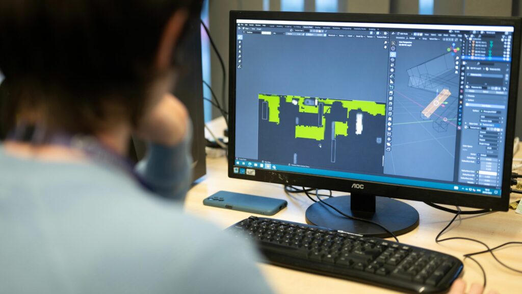 Student using computer software for game development.