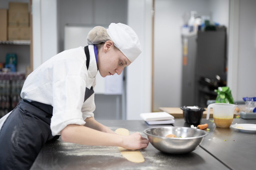 student cooking in professional kitchen