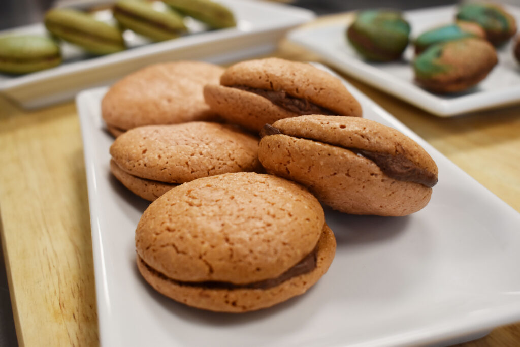 Freshly baked macaron's presented on a china plate