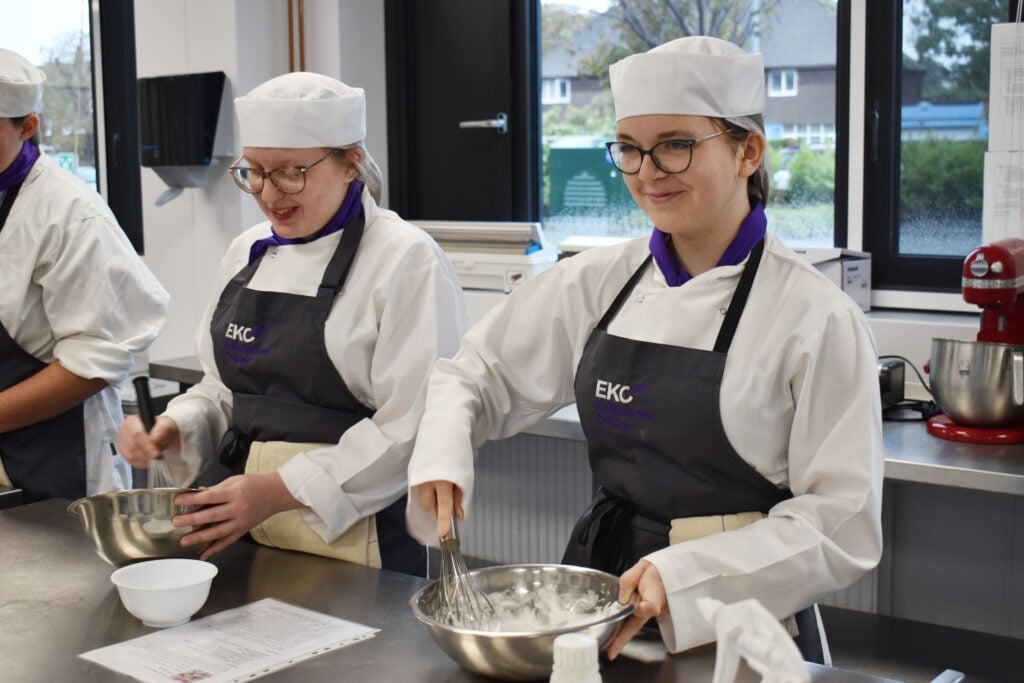 2 students whisking egg whites