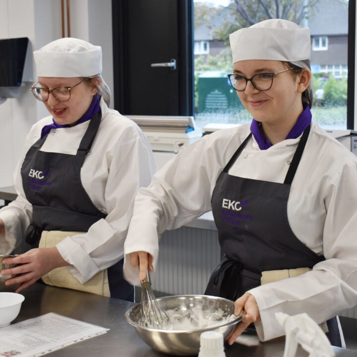 2 students whisking egg whites
