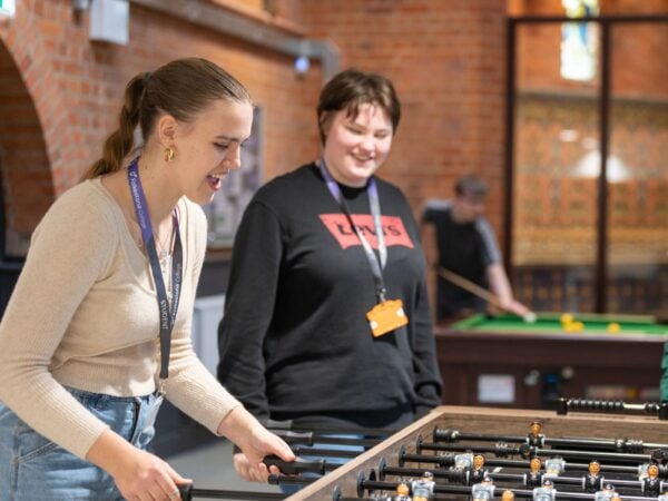 two students playing pool