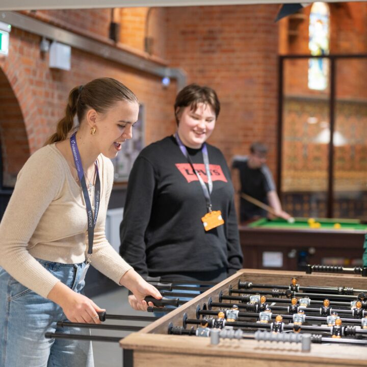 two students playing pool