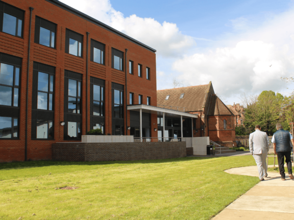 Photo of the EKC Folkestone College building outside in front of the grass.