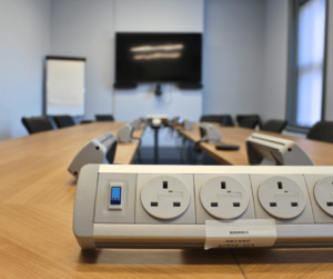 A close up of 4 plugs which are on a long table.