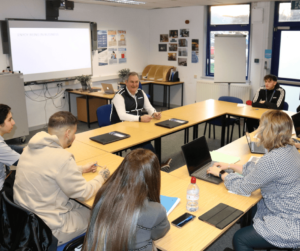 Students and lecturer in a business meeting.