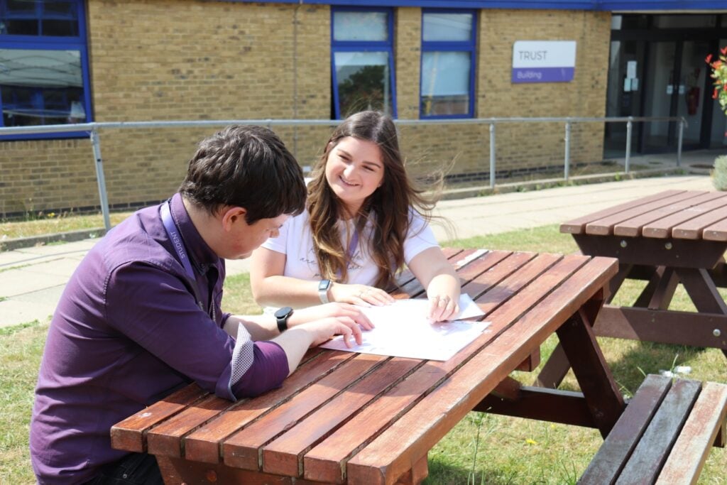 students talking at a picnic table