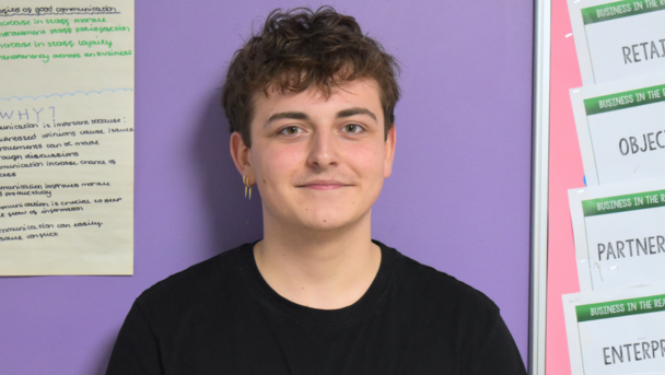 Our student, Oliver, smiling looking at the camera.