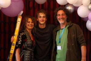 Max smiling with his parents