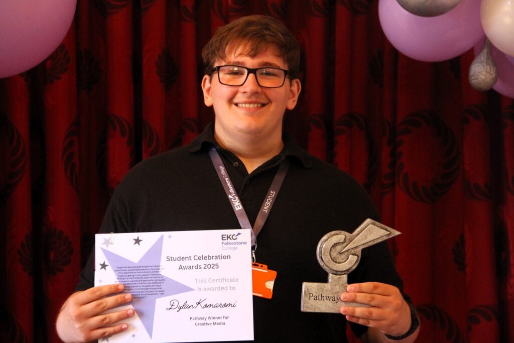 Dylan smiling with his trophy and certificate