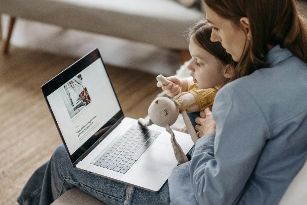 Parent and child looking at a laptop screen