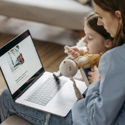 Parent and child looking at a laptop screen