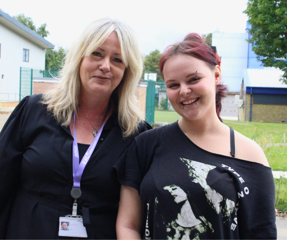 Woman lecturer and Junior College student standing together smiling at the camera.
