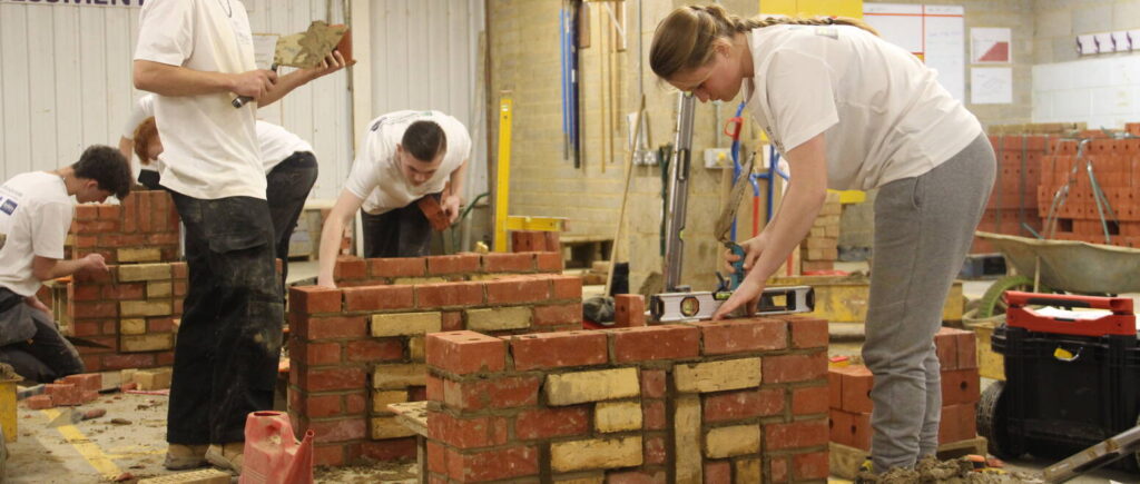 Students building a brick wall for a competition.