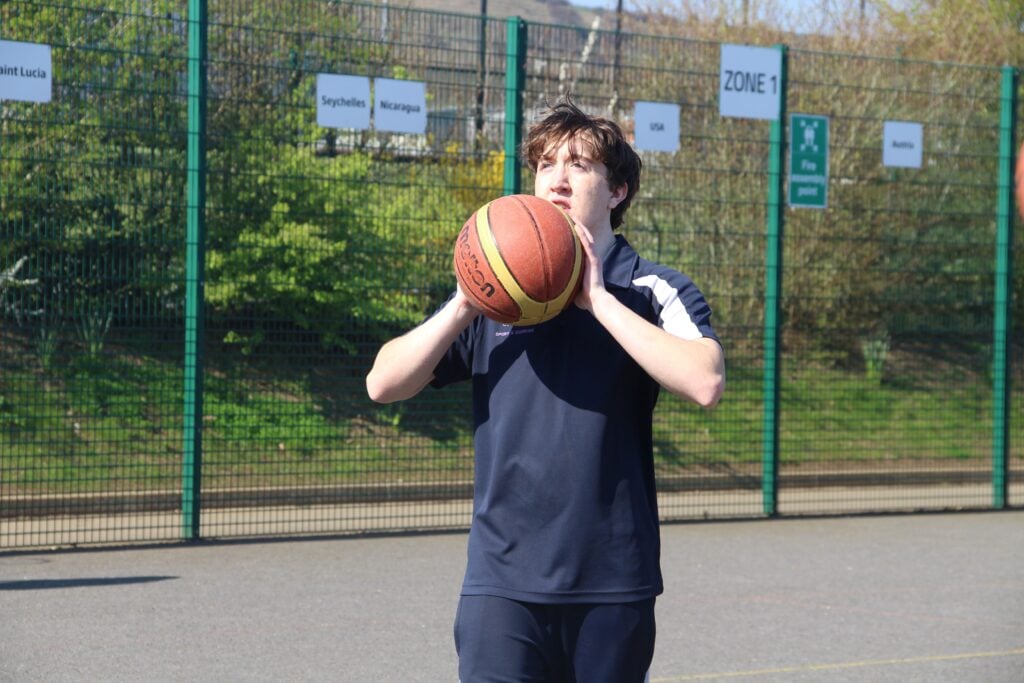 Sports coaching student holding a basketball