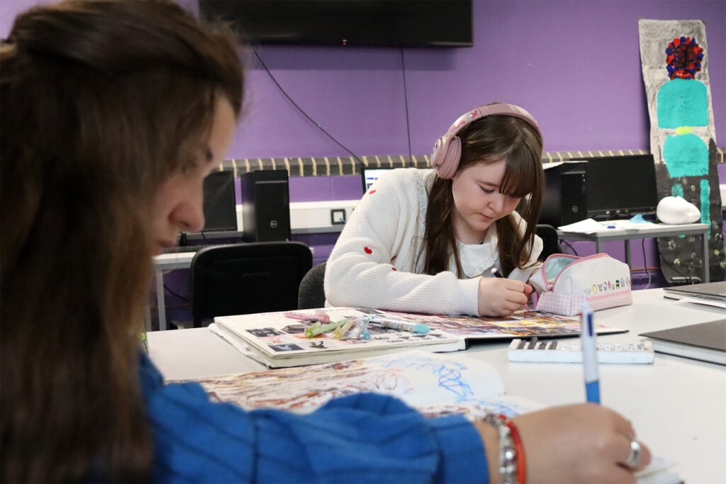 two junior college students work in the classroom