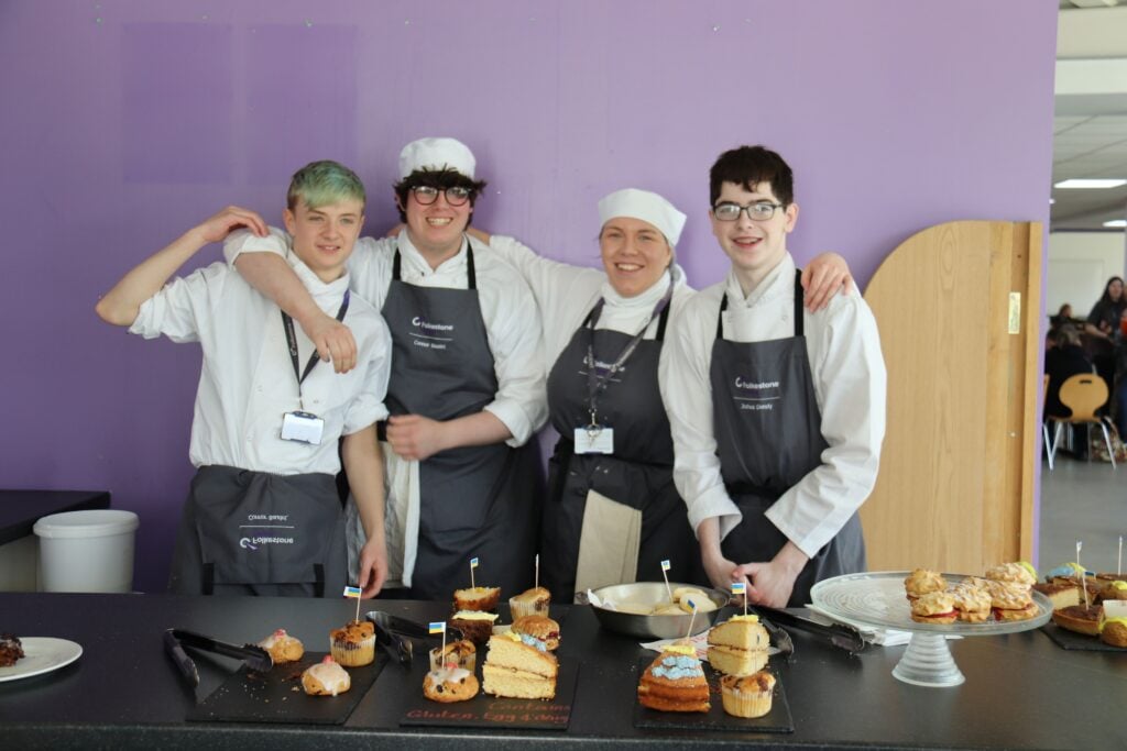students posed with freshly baked cakes