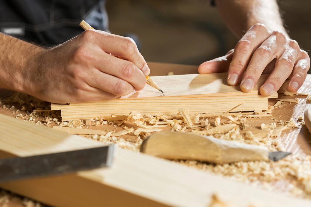 close up of student hands working with wood.