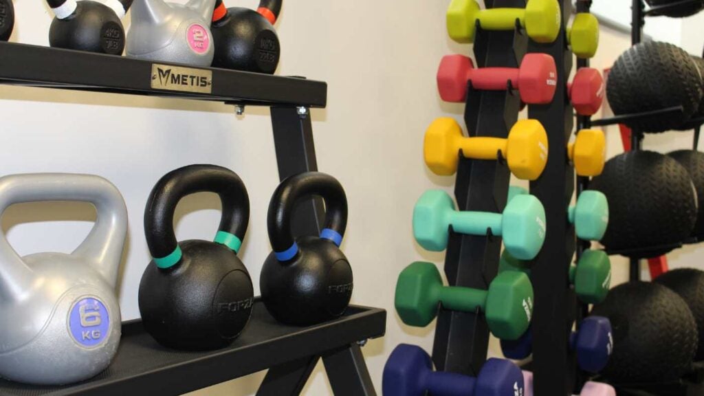 A different selection of free weights including colours dumbbells and kettl bells.